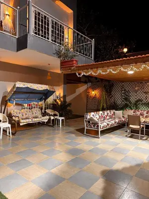 a patio with couches and tables and a balcony at Private villa with pool in Deadsea Jordan in Al Rama