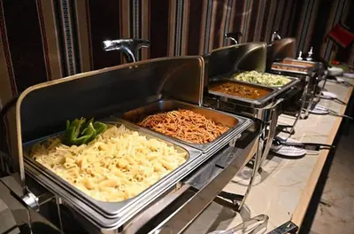 a buffet line with trays of food on at ATAYA sunrise camp in Disah