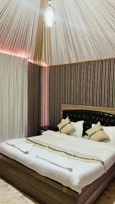 a bed with white sheets and pillows in a room at ATAYA sunrise camp in Disah