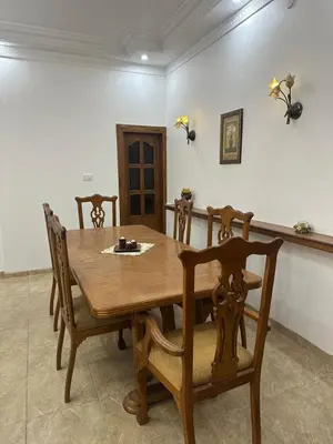 a dining room with a wooden table and chairs at 3 Bedroom Family Apartment in Amman in Amman