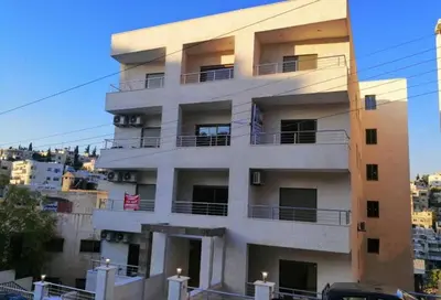 a building with balconies on the side of it at Villa Amman in Al Jafr