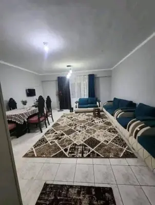 a living room with a couch and a rug at Safari home in Petra