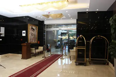 a lobby with a store with escalators and a waiting room at Sandy Palace Hotel Amman in Amman