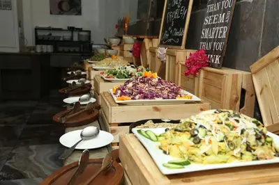 a buffet with many plates of food on display at Sandy Palace Hotel Amman in Amman