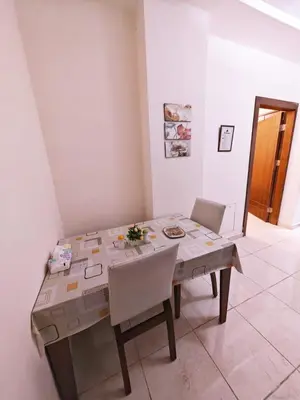 a dining room table with a table and chairs at شقة في ضاحية الرشيد in Amman
