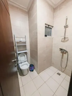 a bathroom with a toilet and a shower at شقة في ضاحية الرشيد in Amman