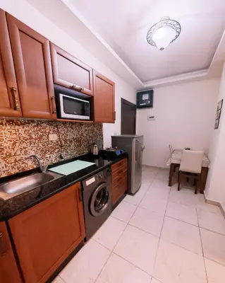 a kitchen with a sink and a dishwasher at شقة في ضاحية الرشيد in Amman