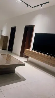 a large flat screen tv sitting on a wall at شقه بغرفة نوم في قريه الراحة one bedroom apartment in alraha village in Al Jafr