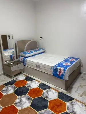 a bedroom with two beds and a checkerboard floor at Marco inn in Amman