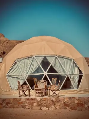 a dome tent with chairs and tables in it at Wadi Rum March in Wadi Rum