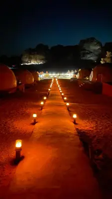 a row of candles on a beach at night at Desert Horizon Camp in Disah