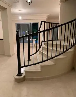 a staircase in a house with a black rail at Jordan farm in Amman