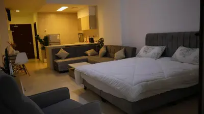 a living room with a bed and a couch at قرية الراحة مرسى زايد باطلالات خلابة alraha village with Beautiful view in Aqaba