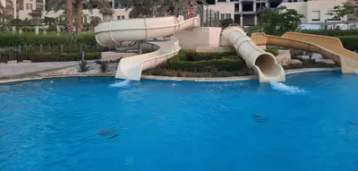 a water slide in a pool at a resort at قرية الراحة مرسى زايد باطلالات خلابة alraha village with Beautiful view in Aqaba