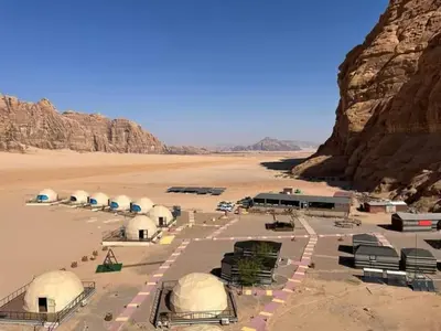 a group of domes in a desert with rocks at Wadi rum sami camp in Wadi Rum