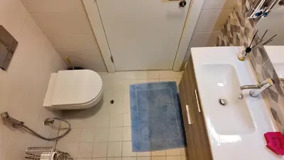 a small bathroom with a sink and a toilet at واحة ايلة ازور in Aqaba