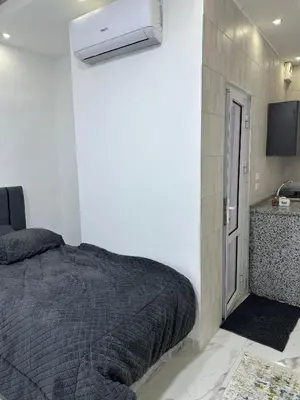 a bedroom with a bed and a television in it at Omar rent apartments in Amman