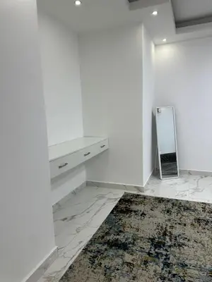 a white room with a mirror and a rug at Omar rent apartments in Amman
