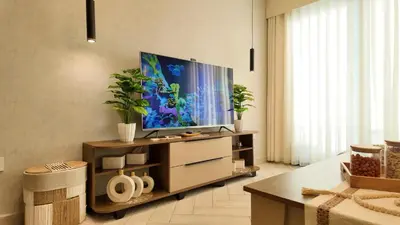 a living room with a flat screen tv on a entertainment center at واحة ايلة ازور in Aqaba