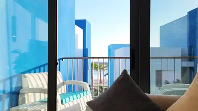 a room with a balcony with a view of the city at واحة ايلة ازور in Aqaba