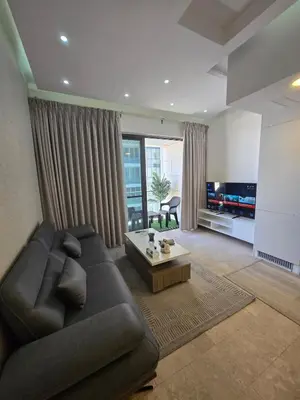 a living room with a couch and a coffee table at Pasha House - DAMAC Tower in Amman