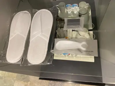 a glass shelf with two white plates and a box at Petra night hostel in Wadi Musa