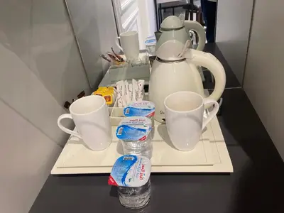 a tea kettle and two cups on a tray at Petra night hostel in Wadi Musa