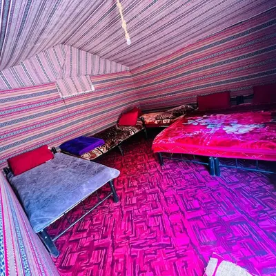 a room with two beds in a tent at Sunrise Magic Camp in Wadi Rum