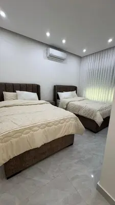 a bedroom with two beds and a window at Luxury 3 Bedroom Family Apartment in Amman in Amman