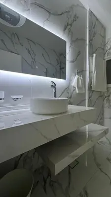 a white bathroom with a sink and a mirror at Luxury 3 Bedroom Family Apartment in Amman in Amman