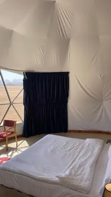 a bedroom with a bed in a tent at TALA lUXURY CAMP in Wadi Rum