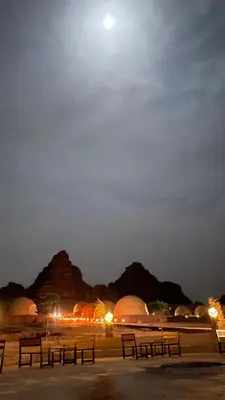 a group of benches in a parking lot at night at Starlight Camp in Disah