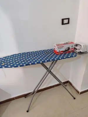 a table with a blue and white table cloth on it at الرائد للشقق المفروشة in Amman