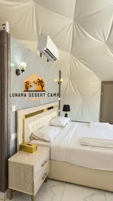 a bedroom with a bed in a tent at Lunara Desert Luxury Camp in Wadi Rum