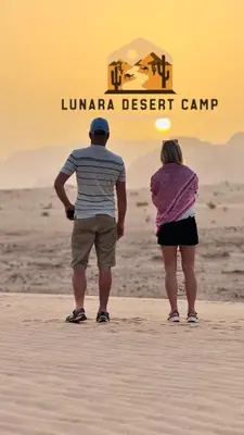 a man and a woman standing on the beach at Lunara Desert Luxury Camp in Wadi Rum