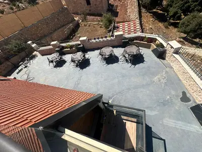 an overhead view of a patio with chairs on a roof at Umm Aljulud Cottages 01 in Ajloun