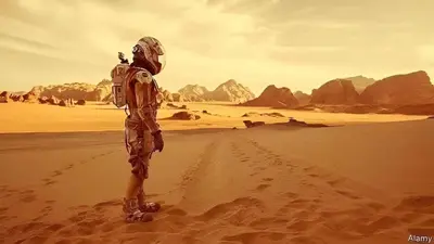 a man walking in the desert at Wadi rum Hi camp in Wadi Rum