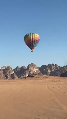 a hot air balloon flying over the desert at The Celestial Dome in Disah