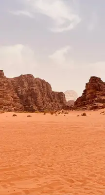 a desert with some rocks in the background at The Celestial Dome in Disah