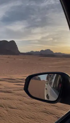 a rear view mirror of a car in the desert at The Celestial Dome in Disah