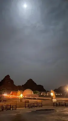 a group of benches in a park at night at The Celestial Dome in Disah