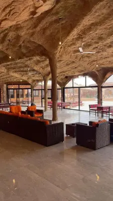 a large room with couches and tables in a building at The Celestial Dome in Disah
