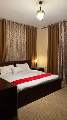 a bedroom with a large bed with a red blanket at Petra center suite in Wadi Musa