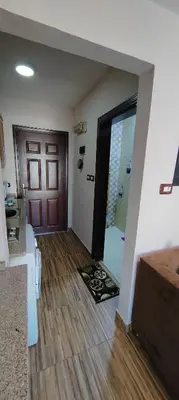 a room with a door and a room with a wooden floor at Fully furnished studio in Amman