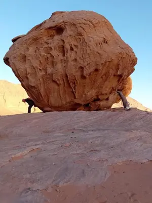 a large rock sitting on top of a mountain at Wadi rum naef camp in Wadi Rum