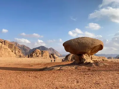 a large rock in the middle of the desert at Wadi rum naef camp in Wadi Rum