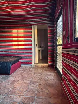 a room with a red and white striped wall at Dana Sunset camp in Nijil