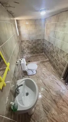 a bathroom with a toilet and a sink at Dana Sunset camp in Nijil