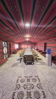 a large room with a long table and chairs at Dana Sunset camp in Nijil