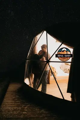 a man is standing inside of a tent at ROYAL SAVOY lUXURY CAMP in Wadi Rum